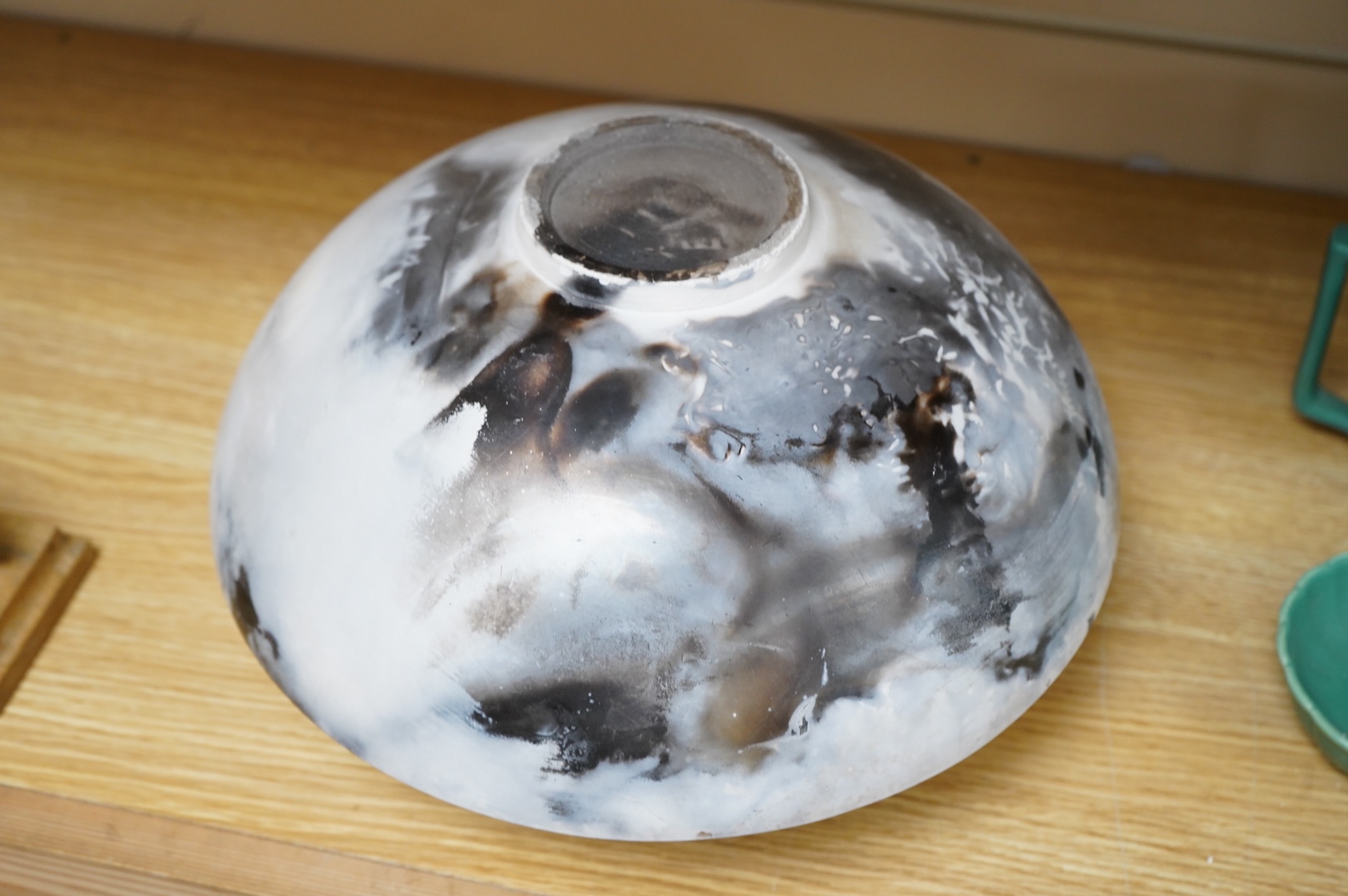 David Harrison (Modern British) a pit fired pottery vase of circular squat form, incised initials to the base, 31cm in diameter